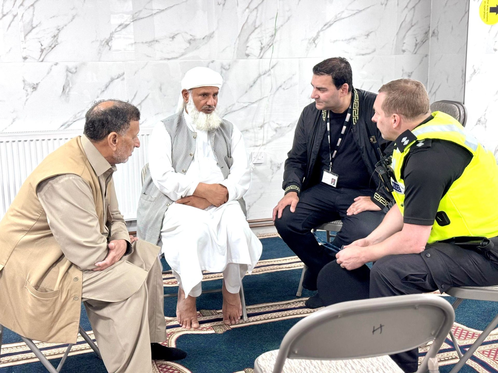Midlands Community Hub founder with elders and West Midlands Police at the mosque