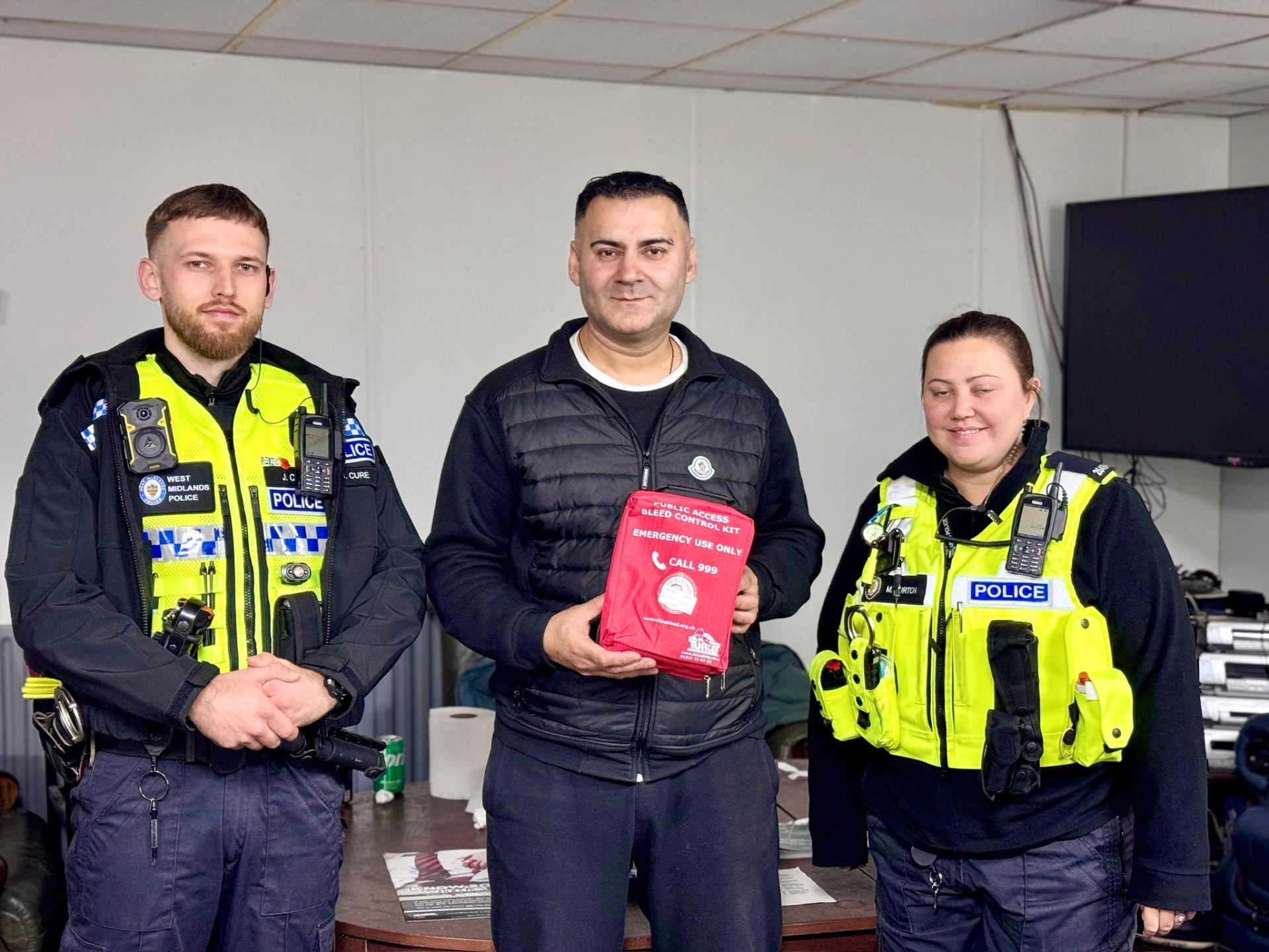 Mohammed Zafran with West Midlands Police presenting bleed control kit