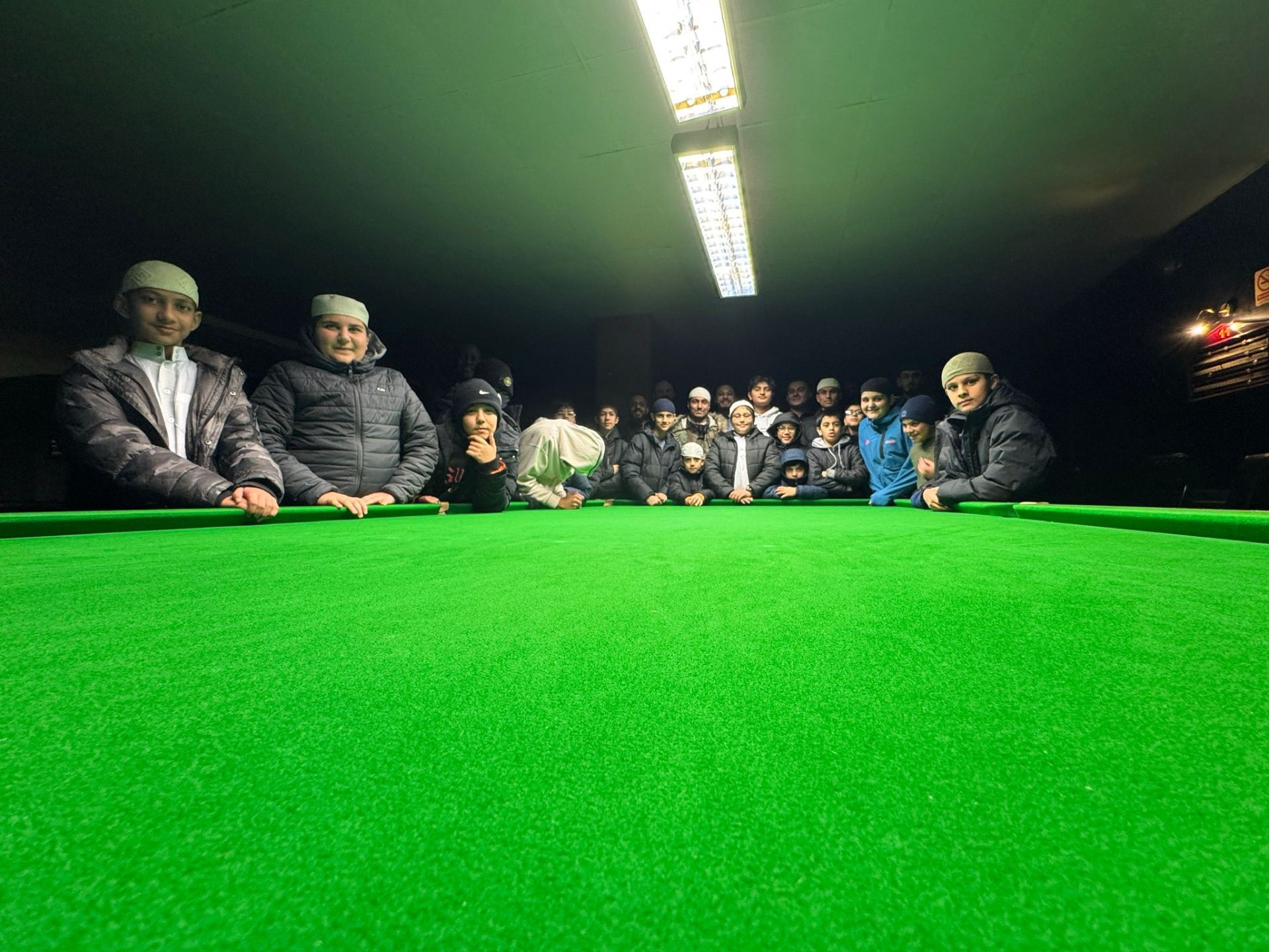 Young people gathered around the snooker table at Midlands Community Hub