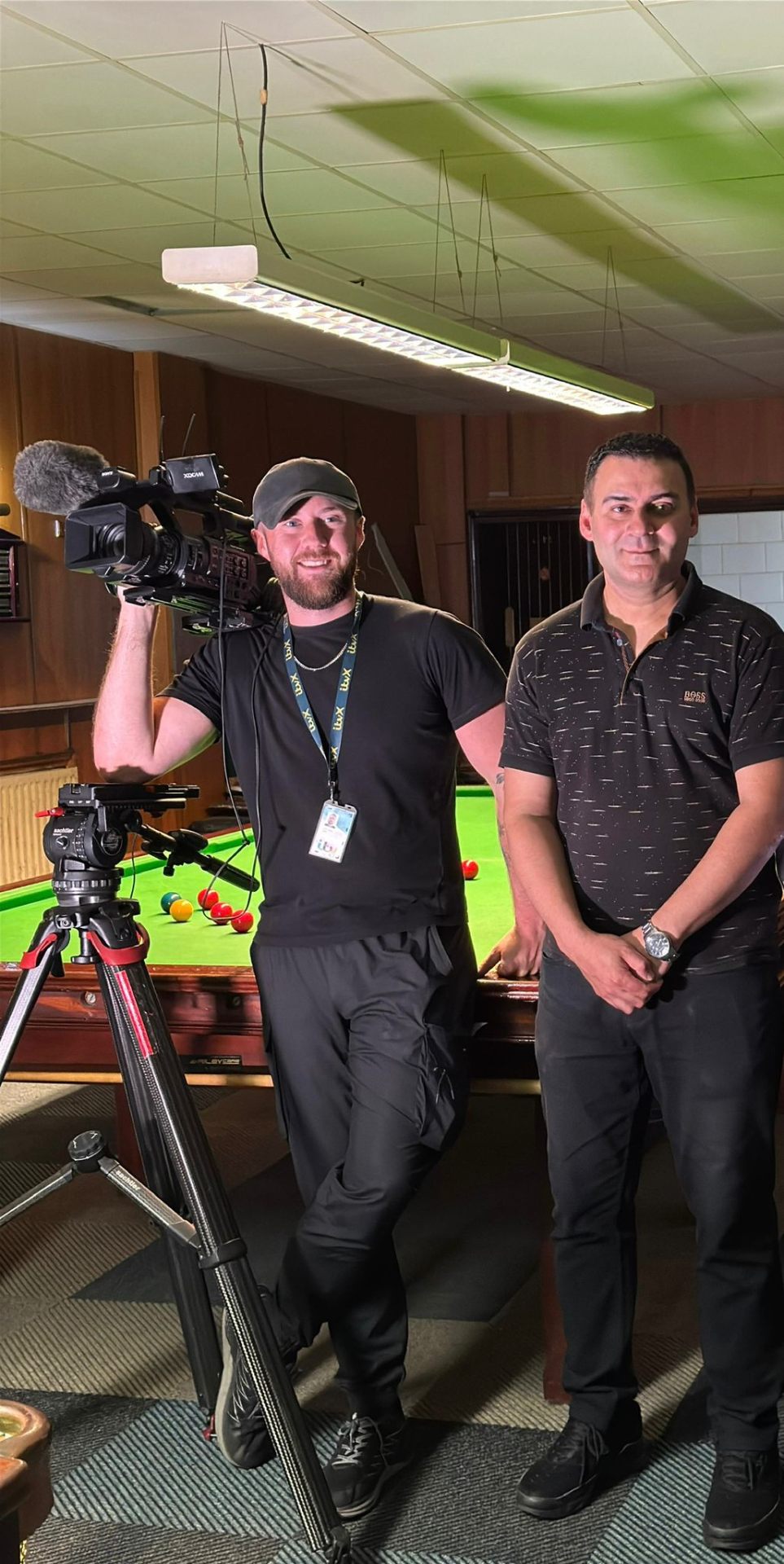 Mohammed Zafran with ITV News camera operator filming at the snooker hall