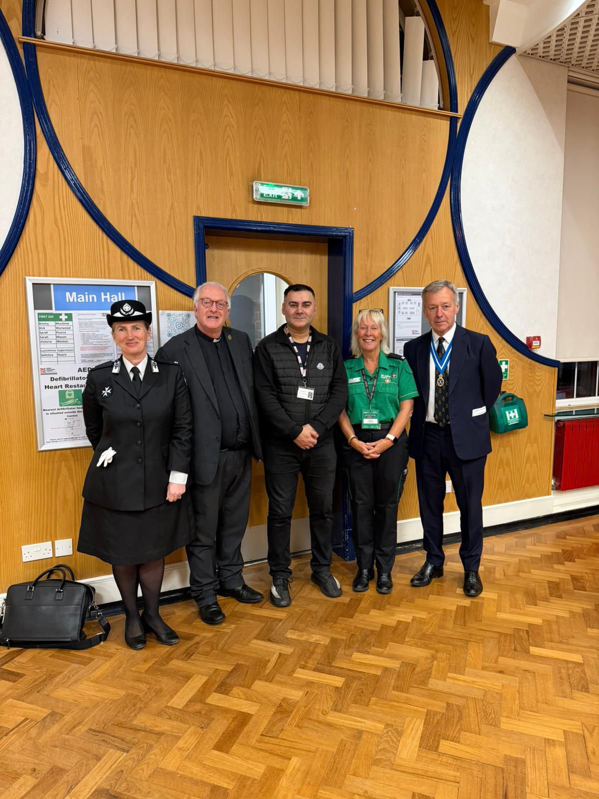 Mohammed Zafran with St John Ambulance, clergy and High Sheriff at community hall