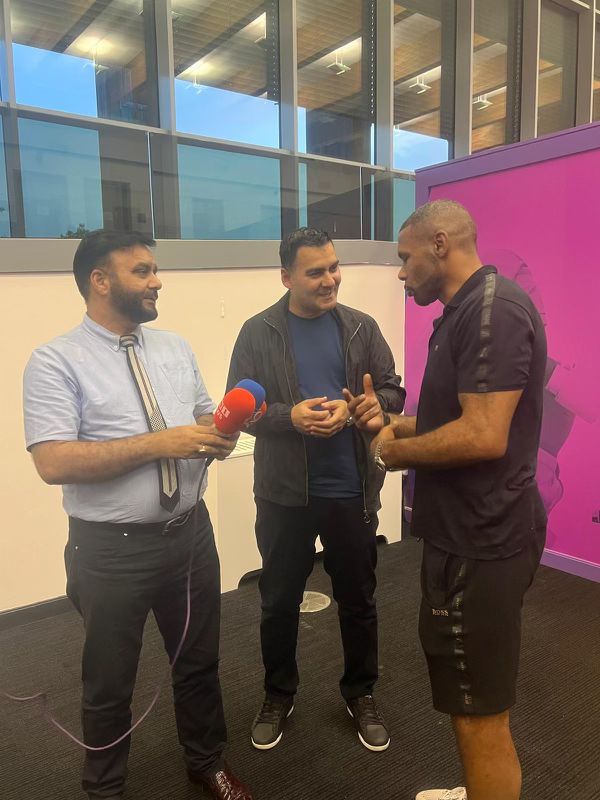 Mohammed Zafran interviewing community guest with reporter