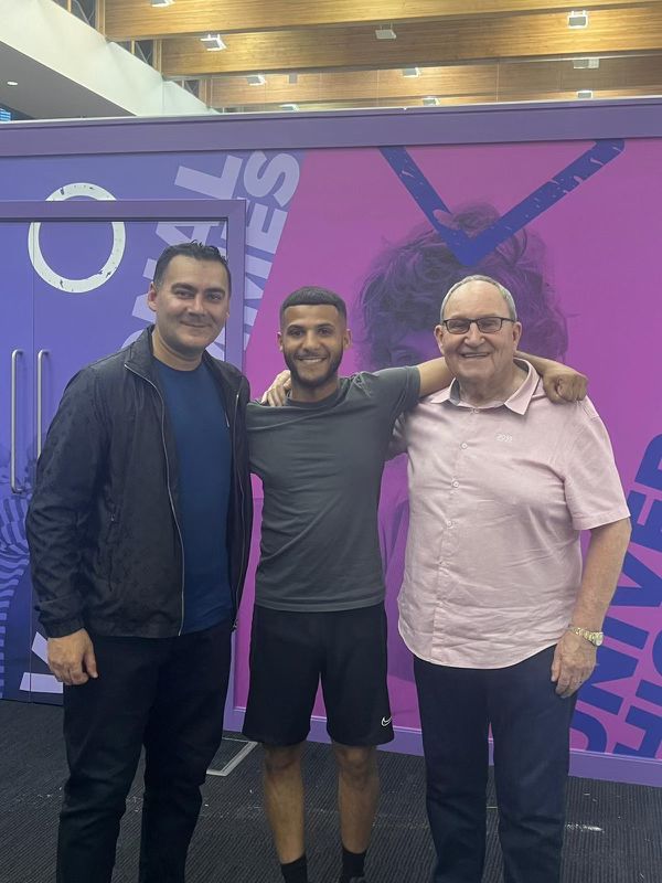 Mohammed Zafran with young athlete and mentor at the National Games