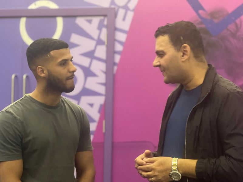 Mohammed Zafran in conversation with young community member at National Games